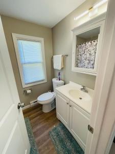 a bathroom with a sink and a toilet and a window at Serenity home in Westfield