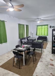 a living room with a couch and a table and chairs at Belle Go in Bauang