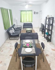 a living room with couches and a table and chairs at Belle Go in Bauang +1 photo