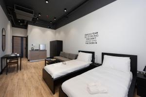 a room with two beds and a couch in it at Designer Stay by Spacey in Duqm 87 in Duqm
