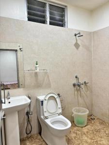 a bathroom with a toilet and a sink at ALPANEST - Near GMCH and B Barooah Cancer in Guwahati