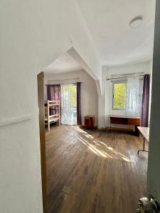 an empty living room with wooden floors and windows at Espacio Zen in Paysandú +8 photos