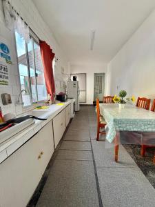 a kitchen with a table and a dining room at Espacio Zen in Paysandú