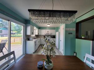 a kitchen with a dining table and a chandelier at Quiet 3BR 2BA Near Mall, Shopping Centers, and I-94 in Eau Claire