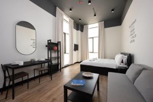 a living room with a couch and a bed and a table at Classic Charm Studio by Spacey in Duqm 88 in Duqm