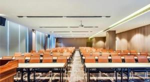 an empty lecture hall with rows of tables and chairs at Echarm Hotel Anshun High-speed Railway Station Jichang Road in Anshun