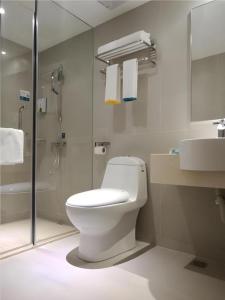 a bathroom with a toilet and a shower and a sink at City Comfort Inn Shenzhen Shiyan Science and Technology Park in Shenzhen +29 photos