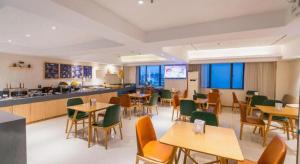a restaurant with tables and chairs and a counter at City Comfort Inn Liuzhou Wuxing Walking Street Zhonghuan Tower in Liuzhou