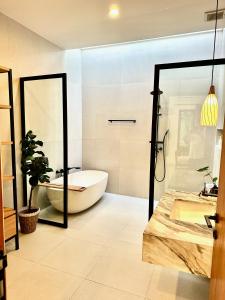 a bathroom with a tub and a toilet and a sink at Villas Topazio and Opalo -- Gateway to Uluwatu beaches in Uluwatu
