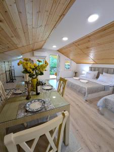 a living room with a dining table and a bedroom at Bodokia winery and guesthouse in Gegut'i
