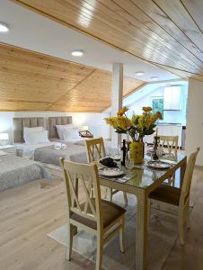 a dining room with a table and a bedroom at Bodokia winery and guesthouse in Gegut'i