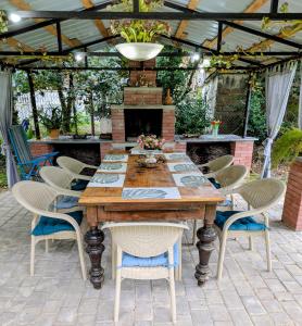 a table and chairs on a patio with a fireplace at Bodokia winery and guesthouse in Gegut'i