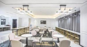 a meeting room with tables and chairs in a building at Xana Hotelle Hengayang Zhengshui Nan Road Dongfang Mingju in Hengyang