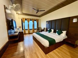 a hotel room with a bed and a television at The Zen Villa in Dalhousie
