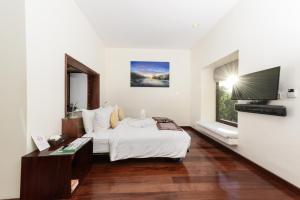 a hotel room with a bed and a television at Luang Prabang View Hotel in Luang Prabang +167 photos