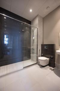 a bathroom with a glass shower and a toilet at Cozy Studio for work Studio by Spacey Duqm 91 in Duqm