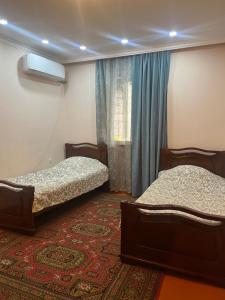 a room with two beds and a window at ДАВТЯН ДОМ in Yerevan