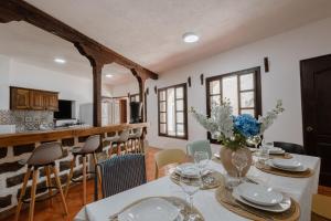 a dining room with a table and a kitchen at Colonial House 8 rooms and private parking in Antigua Guatemala in Antigua Guatemala