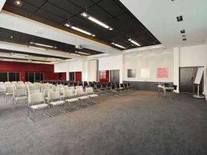 a large room with chairs and a podium in it at Novotel Avignon Centre in Avignon +66 photos