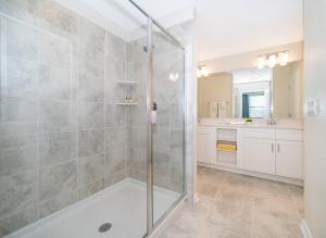 a bathroom with a shower with a glass door at 3171-204AZ STOREY LAKE, CONDO 2/2 LAKE VIEW in Kissimmee +11 photos