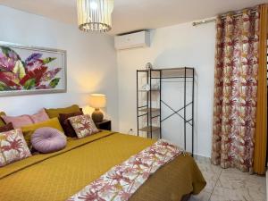 1 dormitorio con 1 cama con edredón amarillo en Madikera Resort, en Saint-François