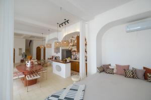 a bedroom with a bed and a dining room at Ocean View 4BR Design Villa with Lap Pool & Rooftop Jacuzzi in Jimbaran