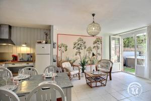 a kitchen with a table and chairs in a room at Villa la lieue de greves in Plestin-les-Grèves