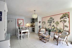 a kitchen and living room with a table and chairs at Villa la lieue de greves in Plestin-les-Grèves +20 photos