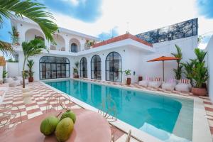 a villa with a swimming pool and a resort at Ocean View 4BR Design Villa with Lap Pool & Rooftop Jacuzzi in Jimbaran