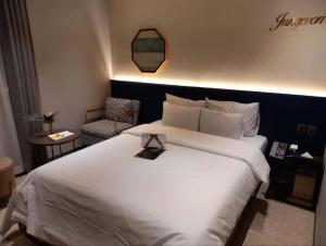 a hotel room with a white bed and a chair at 정원호텔 in Incheon
