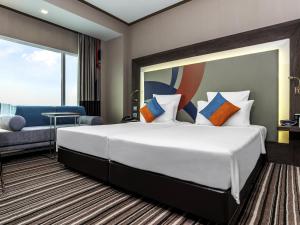 Voodi või voodid majutusasutuse Novotel Bangkok IMPACT toas