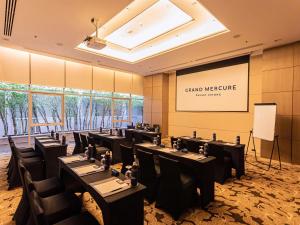 a conference room with tables and chairs and a white board at Grand Mercure Phuket Patong in Patong Beach +46 photos