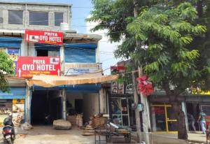 a building with signs on the side of a street at Hotel O Priya in Indraprast