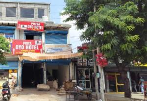 a building with signs on the side of a street at Hotel O Priya in Indraprast +3 photos