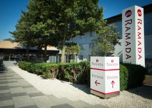 a sign in front of a building at Ramada London South Mimms in Potters Bar