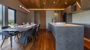 a kitchen and dining room with a table and chairs at Rinzan Chalet by Elite Havens in Niseko