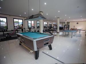 a pool table in a gym with two ping pong tables at Bua Tara Resort in Nong Prue