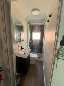 a bathroom with a sink and a toilet at Golf and Beach - by Wehomes in Santander
