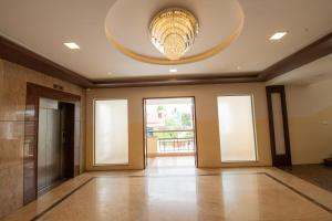 a large room with a large chandelier on the ceiling at Heritage By High Point in Tiruchchirāppalli