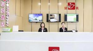 two women sitting at a counter in a store at Shell Taiyuan South Station Shanxi University Hotel in Taiyuan