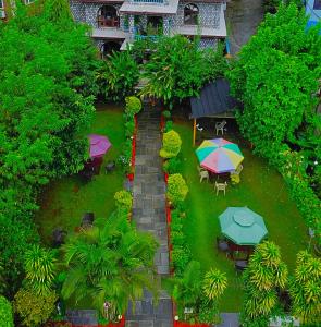 an overhead view of a garden with tables and umbrellas at Hotel Lake Place in Pokhara