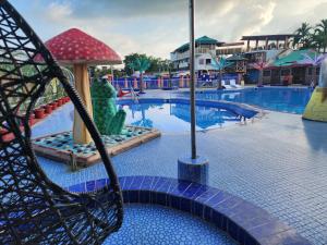 a swing at a resort with a swimming pool at Mukta Nagar Resort in Pitua