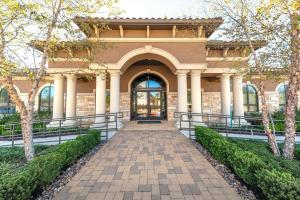 a building with a walkway in front of it at Landing Apartments - Spring, TX in The Woodlands