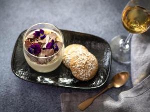 a black plate with a dessert and a glass of wine at Novotel Sydney Parramatta in Sydney +62 photos