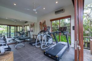 a gym with several treadmills and exercise bikes at Villa Bayad in Payangan