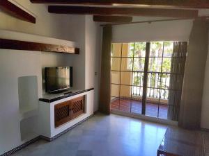 a living room with a tv and a large window at Ona Aldea del Mar in Torrevieja