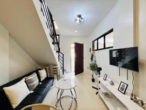a living room with a couch and a tv at 4BR House in Pardo Cebu Perfect for Groups in Cebu City