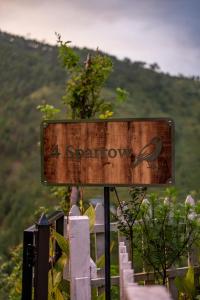 a sign with a bird on it sitting on a fence at Friendship Lane in Sater