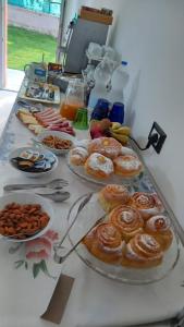 a table topped with plates of pastries and other foods at Agriturismo Ai Progni in Affi