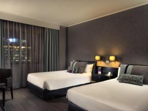 Кровать или кровати в номере Mercure Santiago Centro